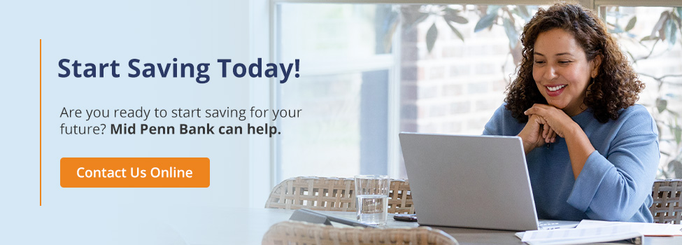 Woman smiling and using a laptop at home